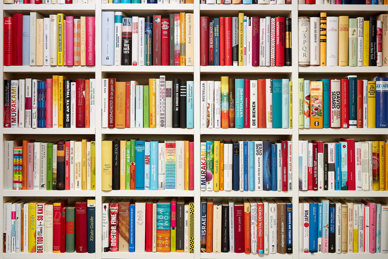 Library, white shelves, multi colored books